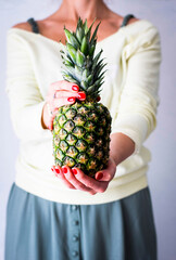 Wall Mural - Woman holding organic pineapple tropical fruit