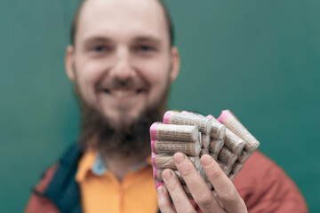 Happy Young Man Holding Firecrackers in his Hand. Bearded Guy Getting Ready for New Year Fun