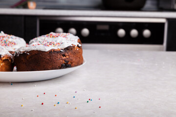 Wall Mural - Close-up of fresh baked goods against backdrop home cooking made from curd dough under layer white glaze - beaten egg whites with sugar, decorated with multicolored round confetti scattered on table.