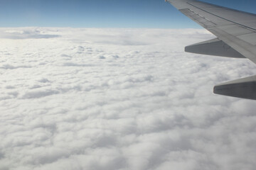 Canvas Print - Clouds and sky as seen through window of an aircraft