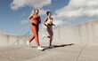 © Jacob Lund - Two women jogging together