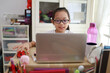 © ltyuan - Portrait of 11-year-old teenager Asian girl using laptop for online study during homeschooling at home