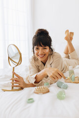 Wall Mural - woman enjoying facial massage at home