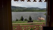View From The Window Of A Beautiful And Large Lake With A Pier. Concept Of Outdoor Recreation. Birds Fly Past The Water