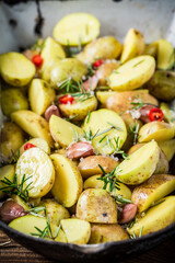 Wall Mural - Closeup of baked potatoes with garlic and cherry tomatoes