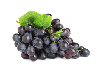 Bunch of fresh ripe juicy dark blue grapes with leaves isolated on white