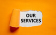 Our services symbol. The words 'our services' appearing behind torn orange paper. Beautiful background. Business and our services concept.