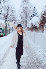 Sticker - Stylish blonde girl with long flying hair posing in the street