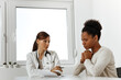 © bnenin - Adult woman talking with doctor.