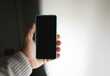 © Jose Prieto - Isolated. copy space. A man holds a smartphone with one hand