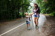 © BalanceFormCreative - Mother and her little sons hiking by the rural country road.Outdoor spring leisure concept.