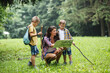 © BalanceFormCreative - Mother and her little sons hiking . They're taking a break and examining the map.