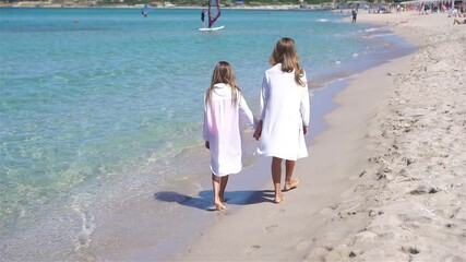 Wall Mural - Adorable little girls having fun on the beach