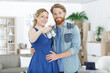 © auremar - portrait of expectant couple holding baby shoes