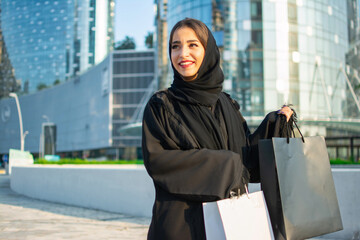 Young muslim woman enjoying shopping time in the city of Abu Dhabi.