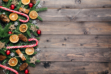 Canvas Print - Fir tree branches with christmas ornaments on brown wooden table