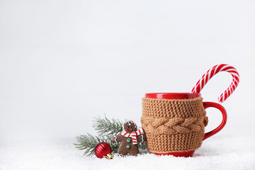 Canvas Print - Christmas drink cup with candy, cookie and fir tree branch on white wooden background