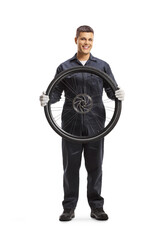 Canvas Print - Mechanic holding a bicycle wheel and smiling at camera