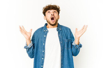 Young arab man on white background screaming to the sky, looking up, frustrated.