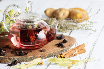 Winter herbs and spices tea in glass teapot or mug, alternative medicine for the immune system, herbal hot drink concept