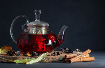 Wall Mural - Winter herbs and spices tea in glass teapot or mug, alternative medicine for the immune system, herbal hot drink concept