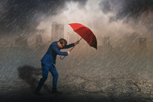 Young Asian Businessman Standing Holding Red Umbrella Protection,rain And Storm,sky And Black Cloud,city Background,with Business,insurance,leadership,working Hard And Pressure,with Fight And Overcome
