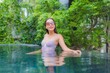 © siraphol - Portrait beautiful young asian woman relax smile leisure around outdoor swimming pool