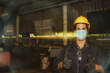 © ฺฺฺBoonterm - Industrial technicians put on safety equipment and masks while working in the factory to prevent the spread of Coronavirus (COVID-19).