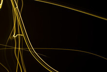 Yellow Light Streaks On A Black Background (long Exposure).