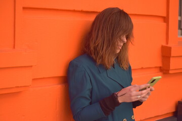 young woman writes a message with her phone