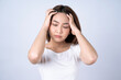 © Basicdog - Beautiful young asian touching her temples feeling stress, Isolated on white background.