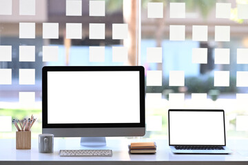 Front view of multiple display devices for responsive web design promotion on modern office desk.