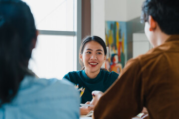 Wall Mural - Group of young college students in smart casual wear on campus. Friends brainstorming meeting talking and discussing work ideas new design project in modern office. Coworker teamwork, startup concept.