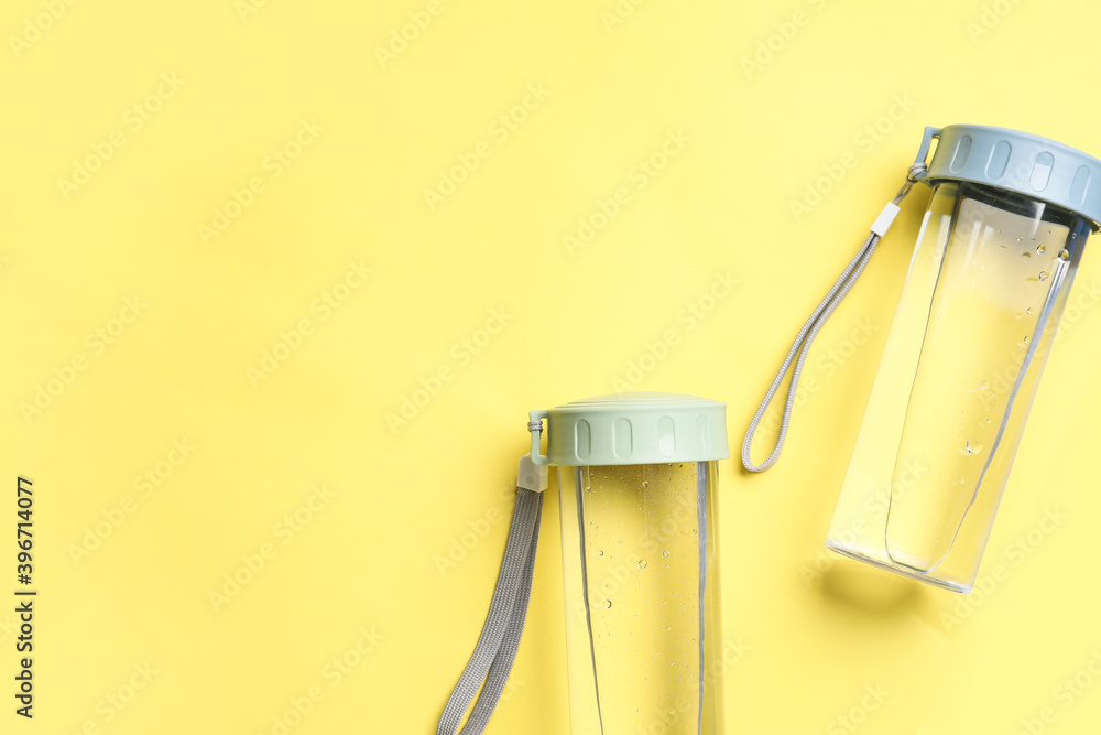 Bottles of water on color background