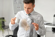 © Pixel-Shot - Stressed young businessman with coffee stains on his shirt in office