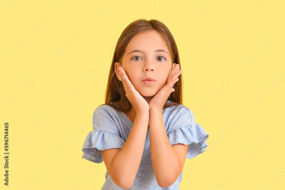 Cute little girl on color background