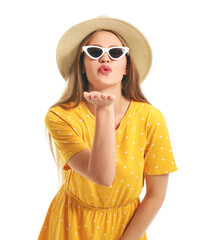 Wall Mural - Beautiful woman with stylish sunglasses blowing kiss on white background