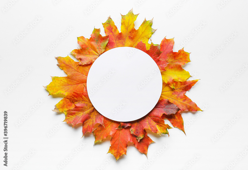 Beautiful autumn composition with leaves and blank card on white background