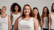 © Svitlana - Portrait of beautiful young caucasian plus size woman in white shirt smiling at camera. Group of diverse women posing, standing isolated over grey background