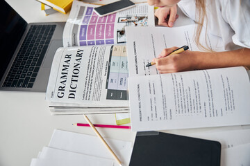 Wall Mural - Schoolgirl underlining a useful rule in a workbook