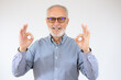 happy positive handsome old man shows Okay sign, no problems, health is Okay everything is okay. close up portrait. isolated white background. happiness, success concept.