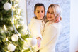 © Angelov - Christmas, happy family mother with daughter with gifts on Xmas Eve