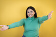 © Irene - Young caucasian woman over isolated yellow background looking at the camera smiling with open arms for hug