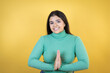 © Irene - Young caucasian woman over isolated yellow background begging and praying with hands together with hope expression on face very emotional and worried