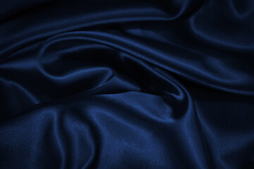 Wall Mural - Dark blue elegant background. Crumpled satin texture background. The surface of a dark blue shiny fabric with nice folds.