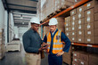 © StratfordProductions - Male warehouse workers discussing about stock while using digital tablet