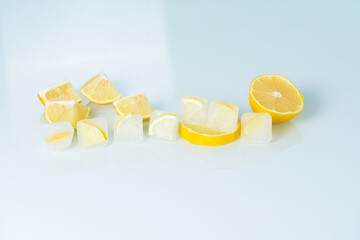 Wall Mural - cosmetic ice cubes with lemon and vitamin C for skin care on a blue light background, natural organic ingredients for home care, detox. place for text