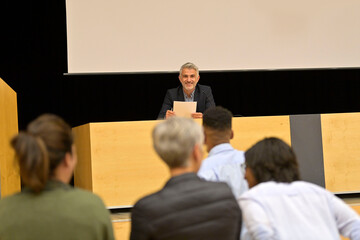 Speaker on the stage with audience in the conference hall