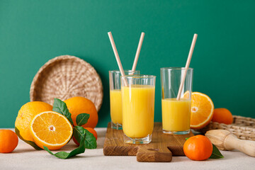 Wall Mural - Freshly squeezed orange juice in a glass pitcher and fresh fruits with leaves, healthy drink, vitamin c concept