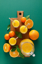 Freshly Squeezed Orange Juice In A Glass Pitcher And Fresh Fruits With Leaves, Healthy Drink, Vitamin C Concept, Overhead View